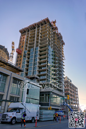 High-rise buildings under constraction with traffic management posts on the road