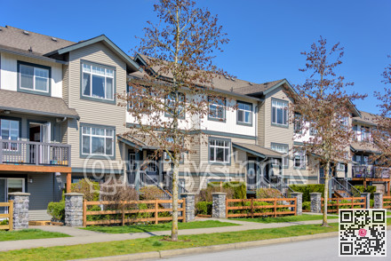 Street of residential townhouses on bright spring day in British Columbia, Canada