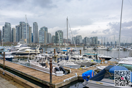Yachts and boats moored at the pier in downtown of Vancouver, Canada