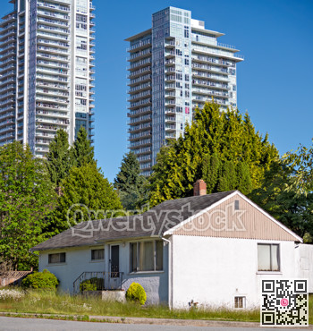 Old residential house on new high-rises background