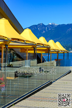 Yellow canopy of street cafe on waterfront in Vancouver