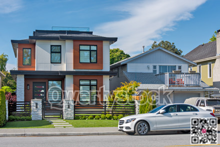 Street of residential houses with cars parked in front