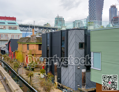 Row of houses on the water with view at downtown of Vancouver, Canada