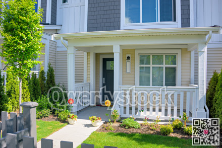Residential house with open patio under the porch on sunny spring day