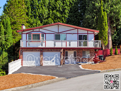Family residential house with double garage and tall trees on the back yard