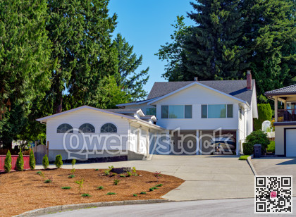 Suburban family house with small boat on trailer parked under carport