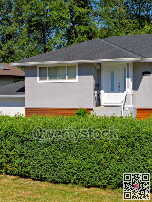 Corner and entrnace door of detached residential house on bright summer day