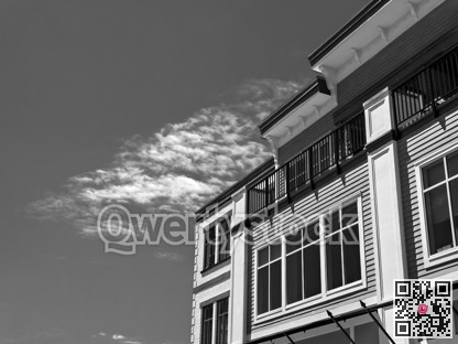 Top of residential building on cloudy sky background on a bright sunny day