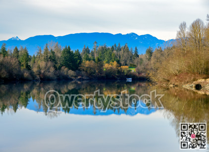 Autumn landscape scene with river, mountains and boat in a quiet factory