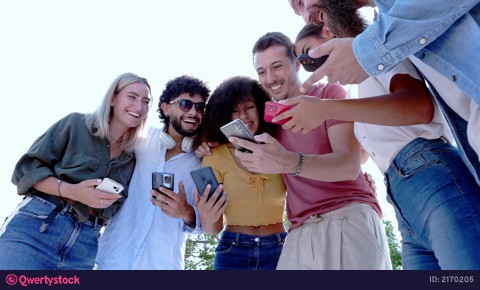 Diverse group of young people using smart phone sharing content in social media video 2170205
